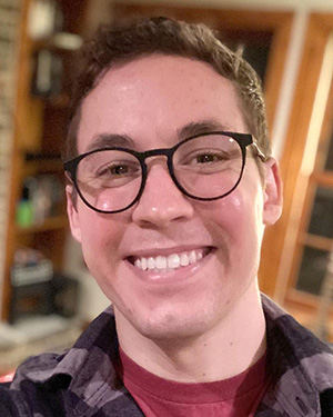 A headshot of a man wearing glasses.