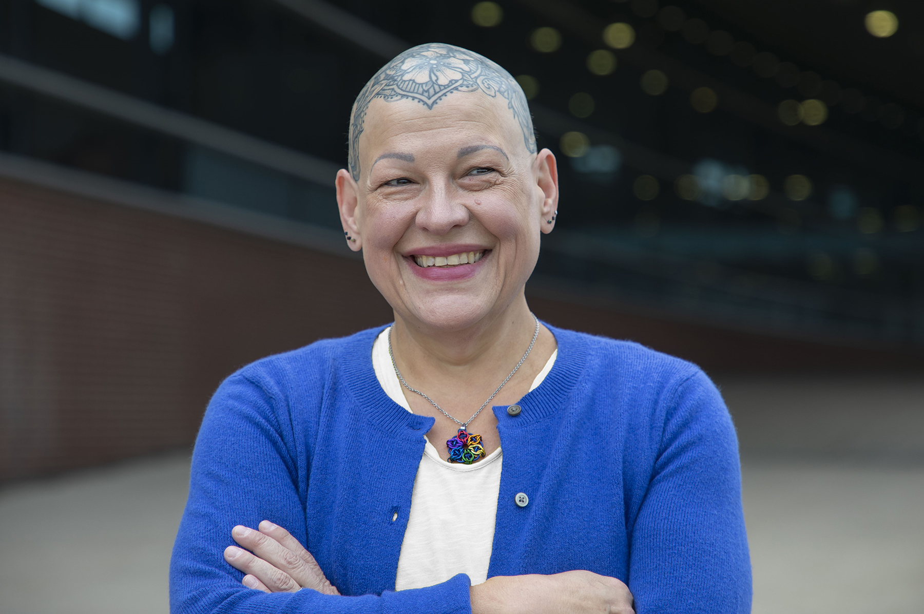 Dean Andrea Tapia smiles at the camera with her arms crossed.