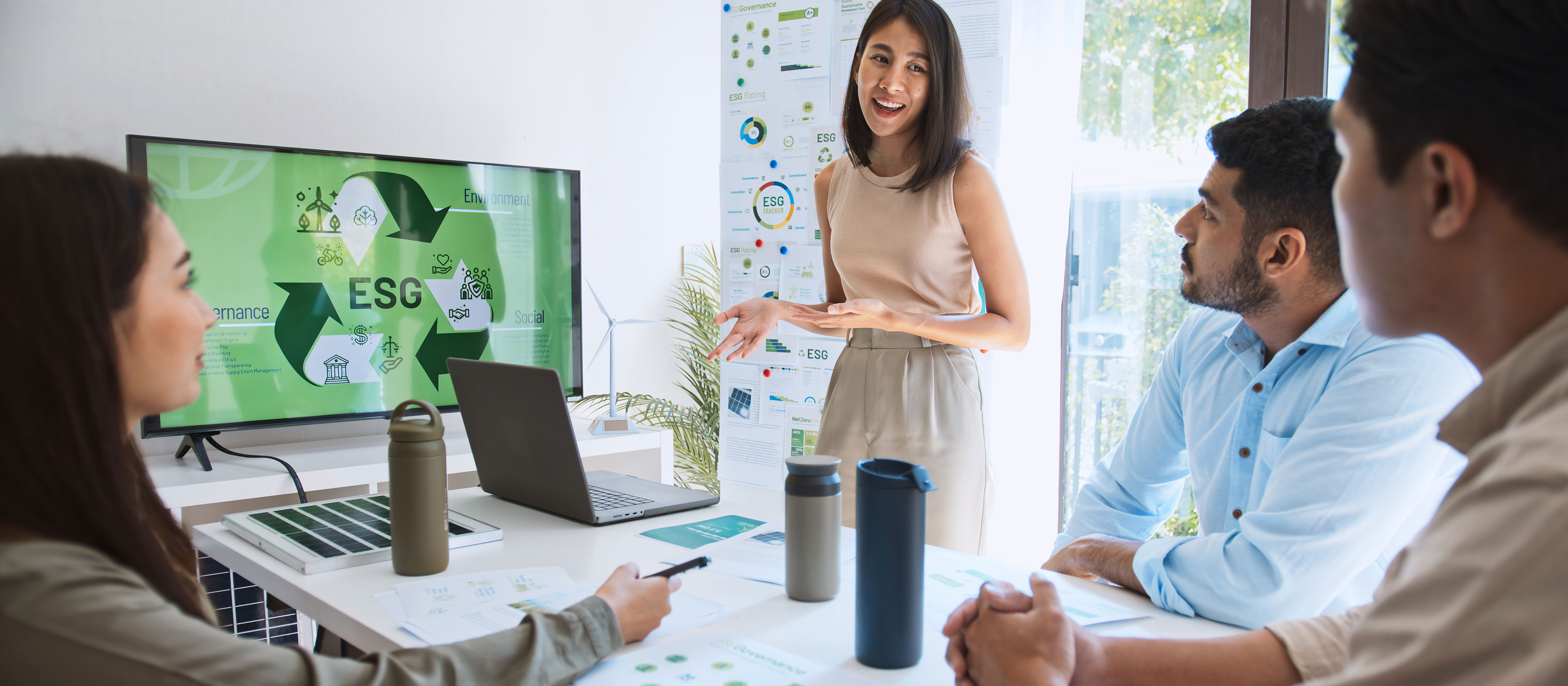 professionals sitting at a table listening to a presentation