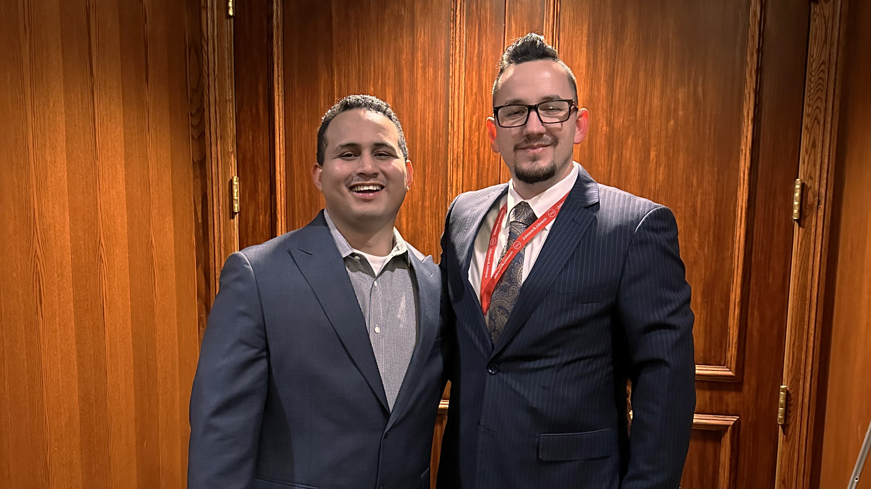 two men pose for a photo