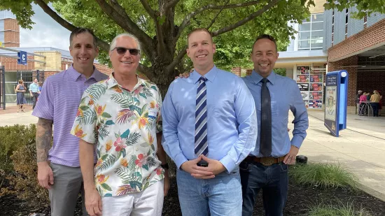 Three members of the U.S. Army Sergeants Major Academy Fellowship pose with a faculty member from Penn State.