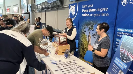 A group of people hand coins out to event attendees.