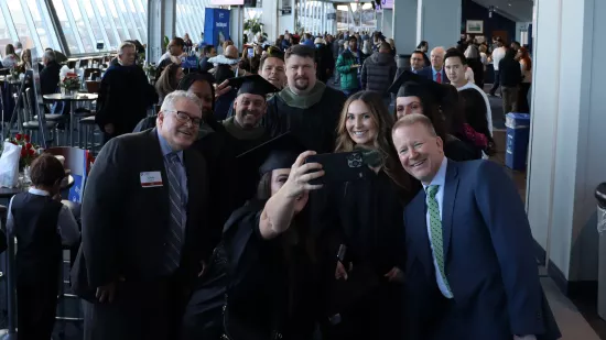 A group of people pose for a selfie.