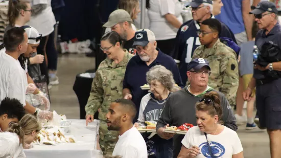 A group of people stand in line.