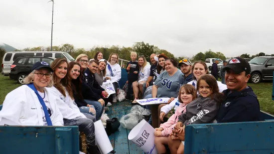 A group of people sit in a wagon.