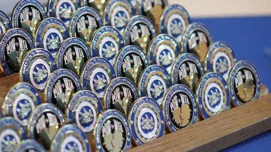 Military challenge coins are displayed.