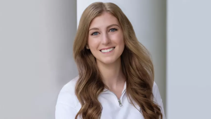 a headshot of Alayna Spriggle with a column in the background