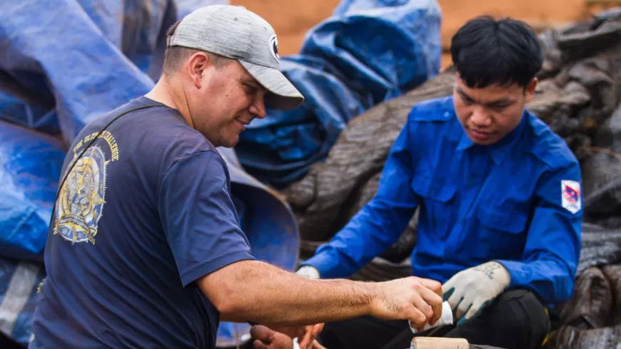 A man provides medical aid to another man.