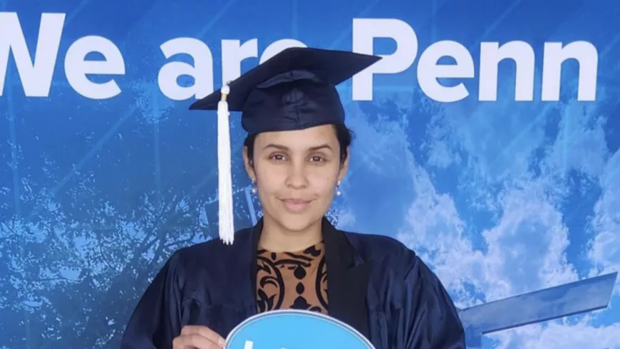 graduate in a cap and gown holding a sign that reads 'I did it!'